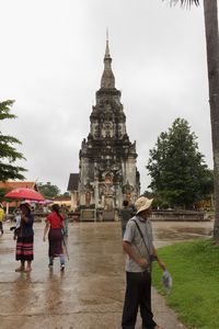 People at temple against sky