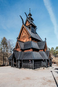 Traditional windmill on old building against sky