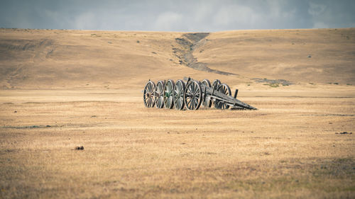 Bicycle on field against sky