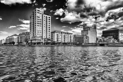 Cityscape against cloudy sky