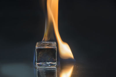 Close-up of burning ice over black background