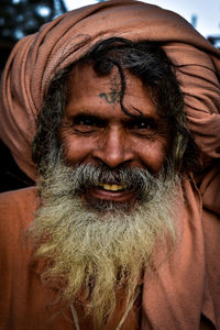 Close-up portrait of smiling bearded man wearing turban