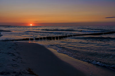 Scenic view of beach against sky during sunset