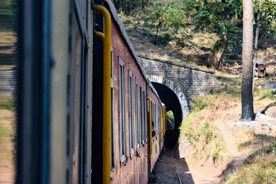 Toy train moving on mountain slopes, beautiful view, one side mountain, one side valley moving