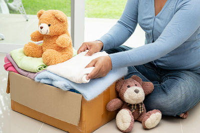 Midsection of woman sitting on sofa