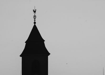 Low angle view of silhouette built structure against clear sky