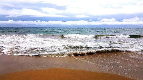 Scenic view of sea against cloudy sky