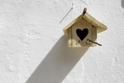 Low angle view of birdhouse on building