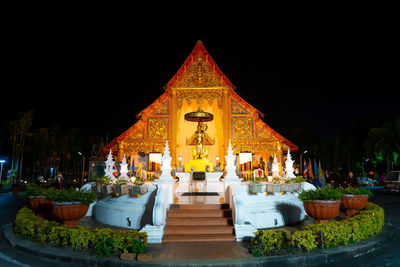 Illuminated temple outside building at night