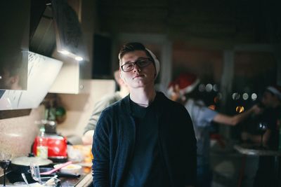 Portrait of young man standing at home