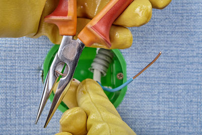 Cropped hands of electrician working on electrical equipment