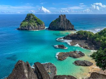 Panoramic view of rocks on beach against sky