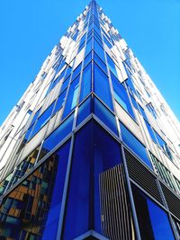 Low angle view of modern building against clear blue sky