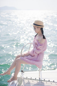 Woman sitting in boat on sea