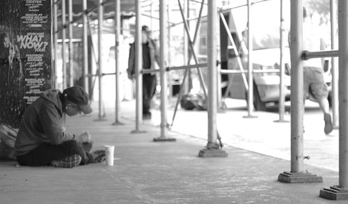 Full length of woman sitting on bench