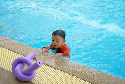 High angle view of boy swimming in pool