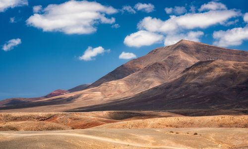Scenic view of arid landscape on lanzarote against sky