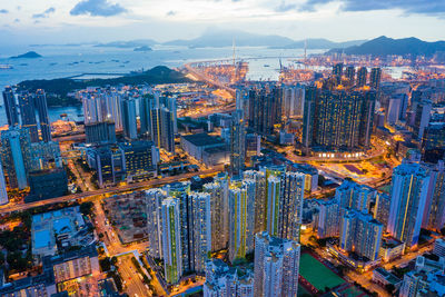 High angle view of illuminated city buildings against sky