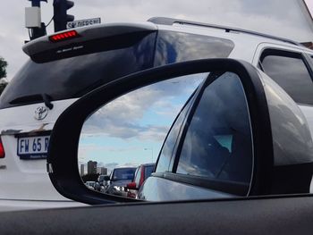 Reflection of sky on side-view mirror