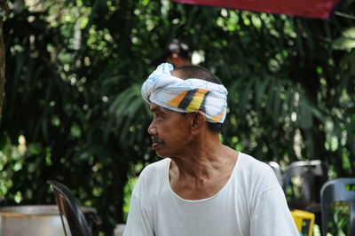 Mature man wearing headscarf