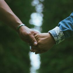 Close-up of couple holding hands