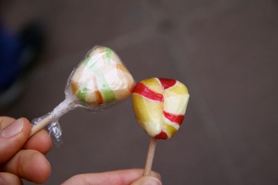 Cropped hand holding ice cream cone
