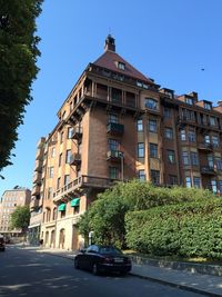 Buildings in city against clear blue sky