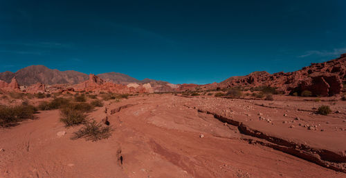 Scenic view of desert against blue sky