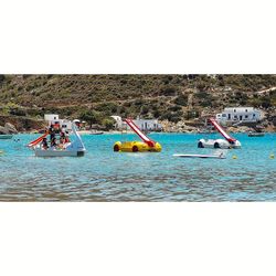 People enjoying in sea against clear sky