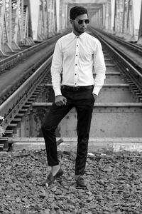 Full length of man standing on railroad track