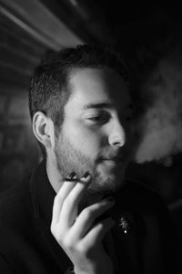 Close-up portrait of young man smoking