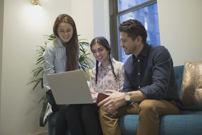 Young professionals working on laptop in an office