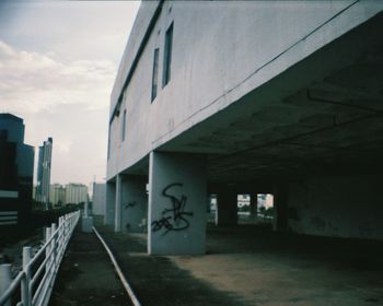 Narrow walkway along empty road