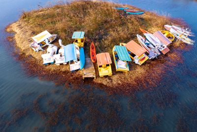 High angle view of boats on field by lake