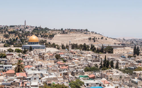 High angle view of temple amidst city against clear sky during sunny day