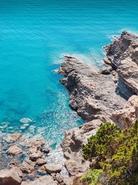 High angle view of rocks by sea