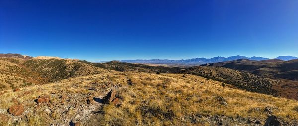 Scenic view of mountains against clear blue sky