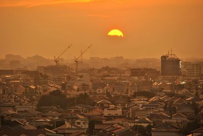 High angle view of buildings in city during sunset