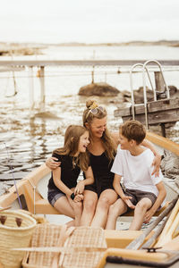 People sitting on boat in sea