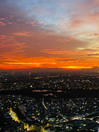 High angle view of illuminated cityscape against sky during sunset