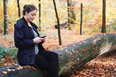 Low angle view of young man standing in forest