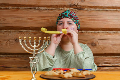 Portrait of girl eating food on table