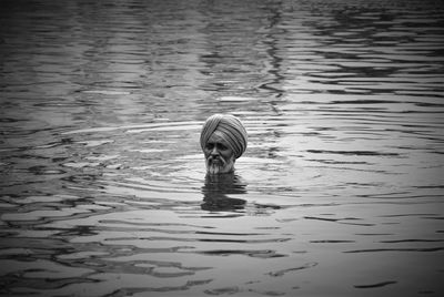 Man wearing turban swimming in lake