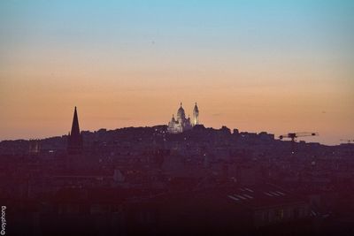 Buildings against sky at sunset