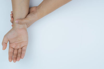 Close-up of woman hand over white background