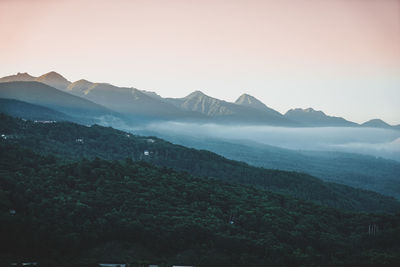 Scenic view of mountains against clear sky during sunset