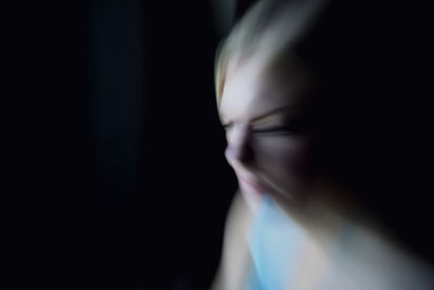 Close-up of woman in darkroom