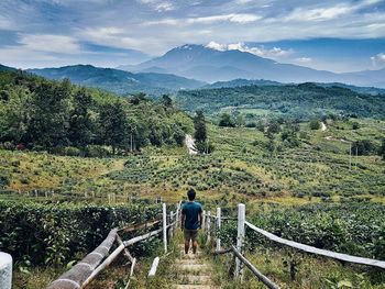 High angle view of man standing on steps against mountains