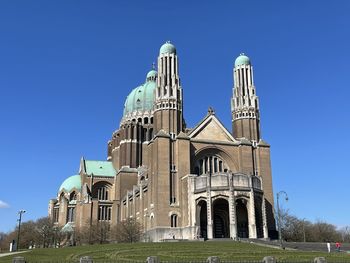 Low angle view of historic building against clear blue sky