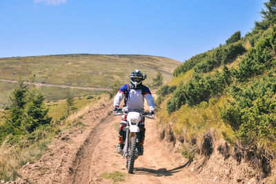 Man riding motorcycle on road